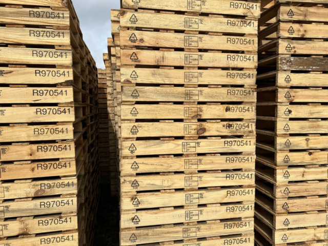 rows of stacked marked pallets