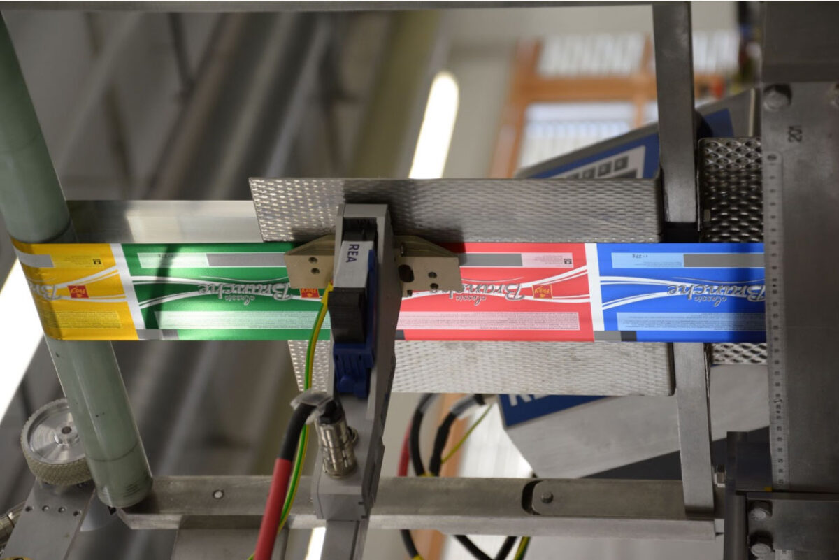 Industrial coding equipment operating on a high-speed manufacturing line
